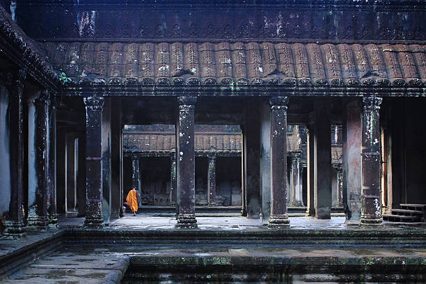 Buddhist monk in Angkor wat Buddhist monk walking in Angkor Wat, Siem reap, Cambodia traveled stock pictures, royalty-free photos & images