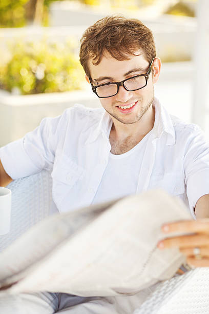 istock Man reading newspaper nature background 527554481