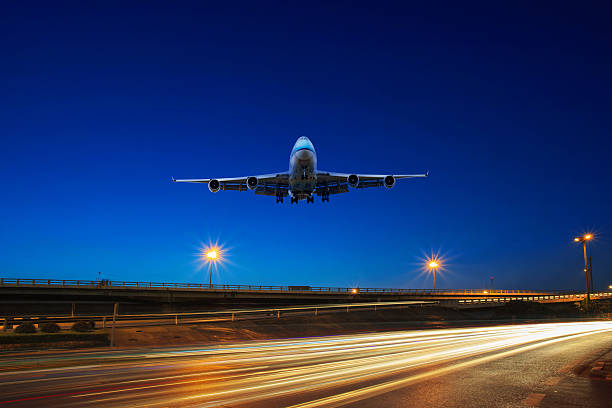 istock passenger plane flying above urban road scene 527557265