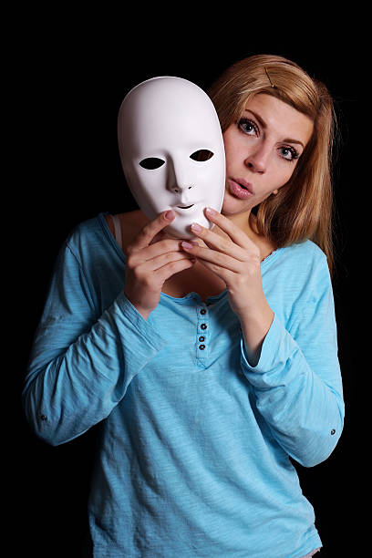 istock woman taking off mask 527558235