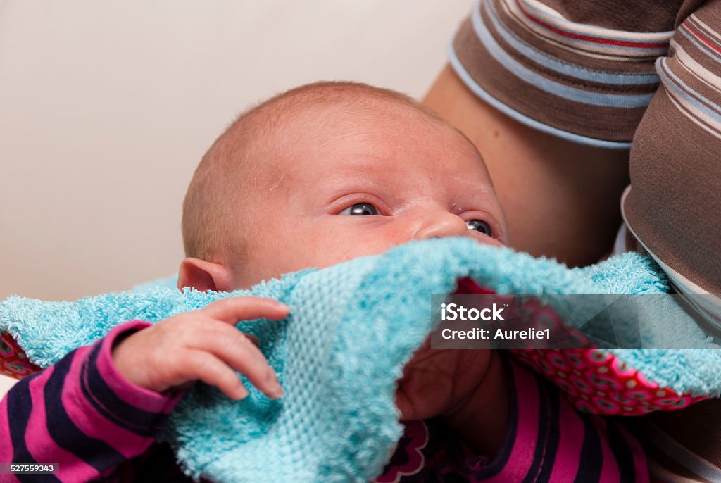Newborn playing Newborn babygirl (three weeks) playing with her bib Baby - Human Age Stock Photo