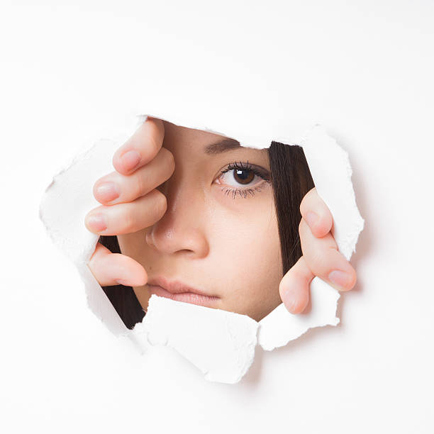 istock young asian woman peeking 527568569