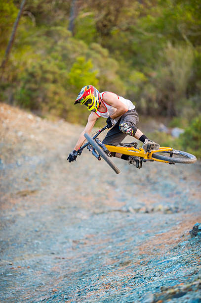 Young man doing bike jump
