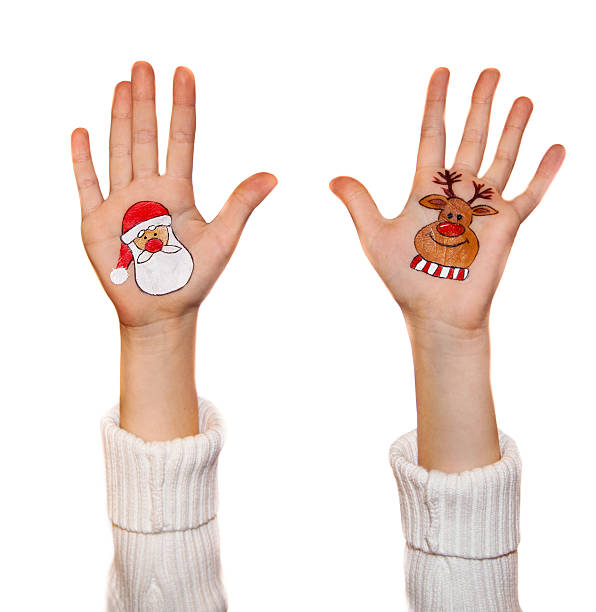 istock Kid's hands with painted Christmas symbols 527569215