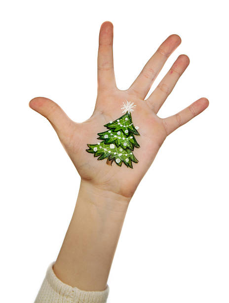 istock Kid's hands with painted Christmas symbol 527569819