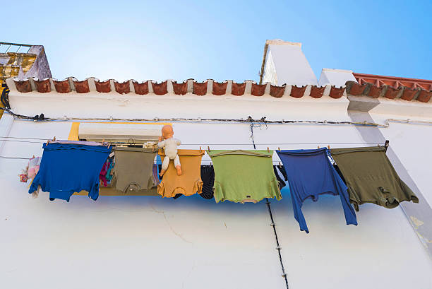 clothes hanging with two dolls in Evora, Portugal