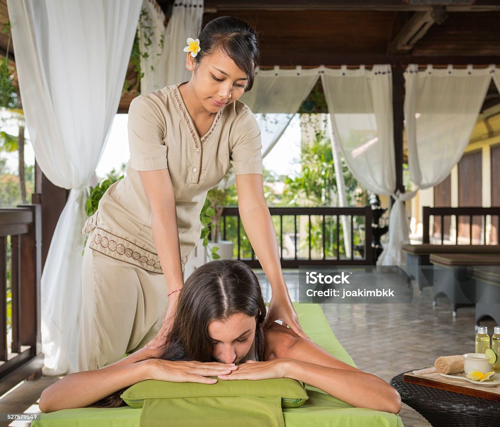 Young woman having a massage treatment Young lady getting a massage therapy in a luxury resort. Luxury Stock Photo