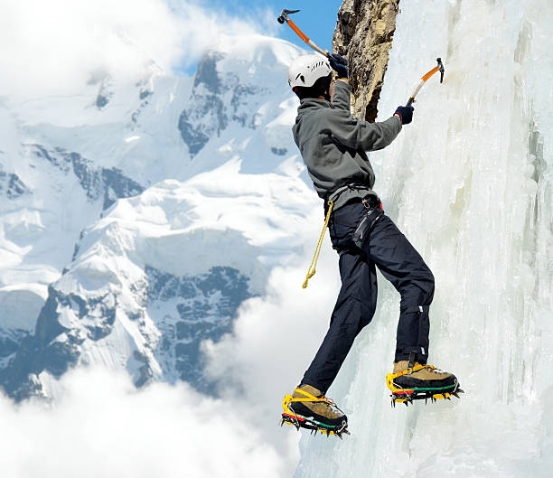 istock Man climbing on icefall in winter mountains 527580709