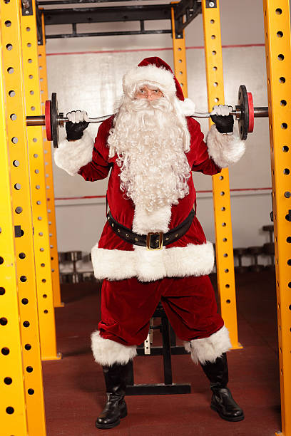 istock Santa Claus lifting weights - training before Christmas 527581751