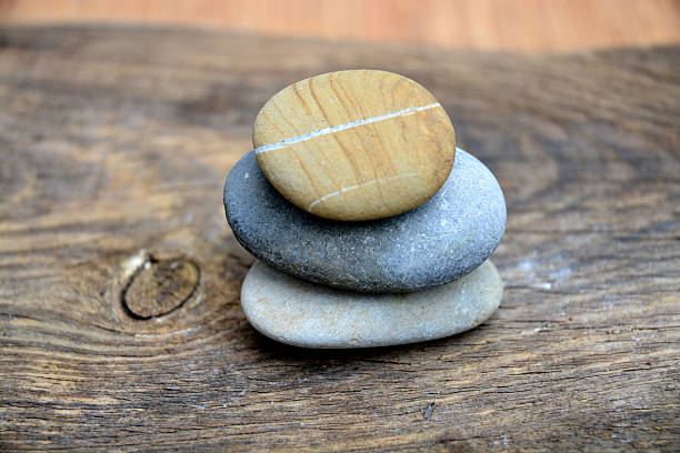 istock Three Zen stones on ols used wood 527582315