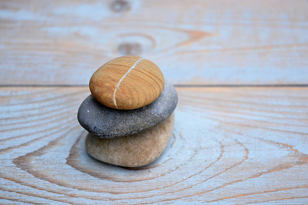 istock Three Zen stones on ols used wood 527582603