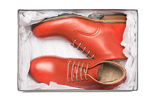 new red shoes in box new red shoes in box with wrapping paper brogue photos stock pictures, royalty-free photos & images