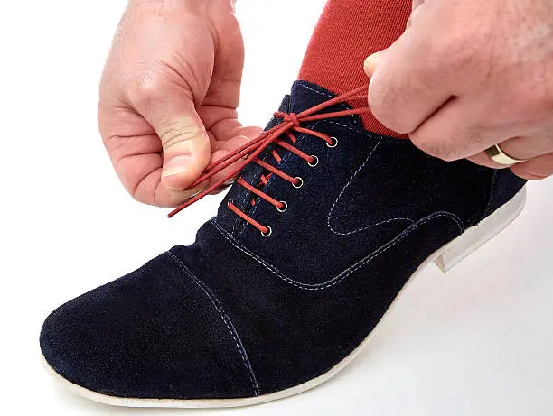 Tighten the laces on suede leather shoe