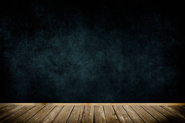 istock Wooden frame on dark grunge wall. 527584343