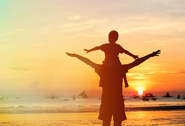 istock father and son having fun on sunset 527584387