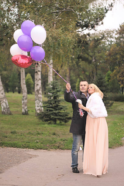 istock Young couple with baloons 527585829