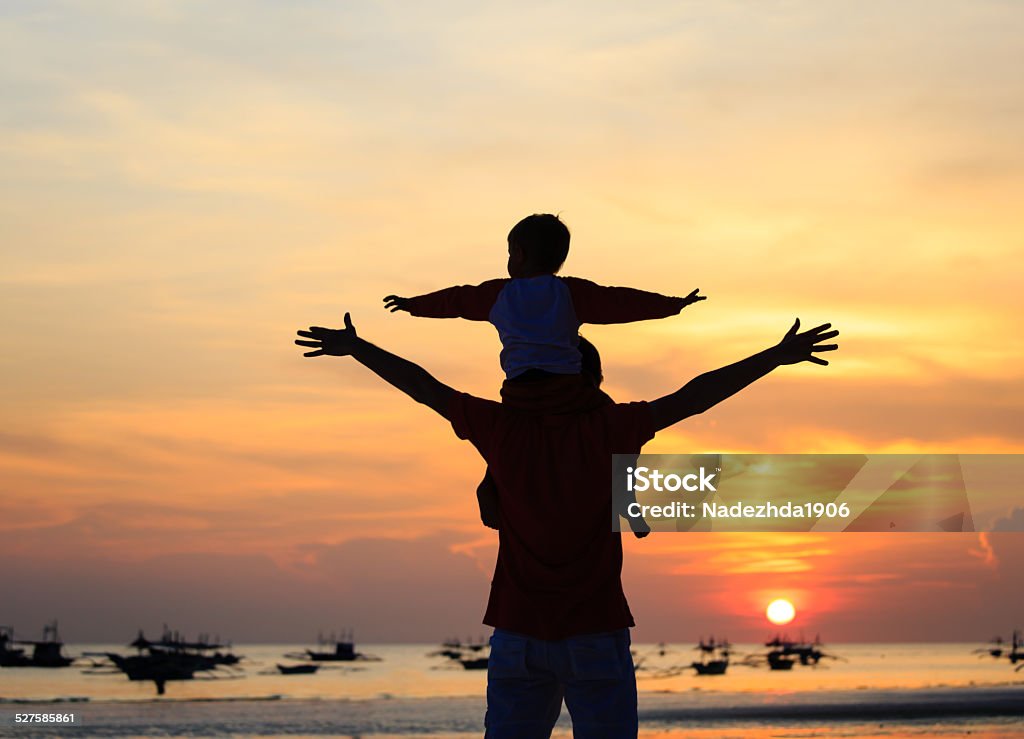 father and son having fun on sunset father and son having fun on sunset beach Activity Stock Photo