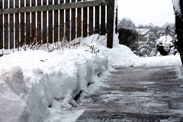 istock Pathway of cleared snow on residential driveway, UK 527612229