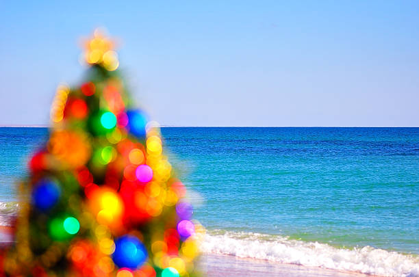 istock Blurred christmas tree on the sand in the beach 527612539