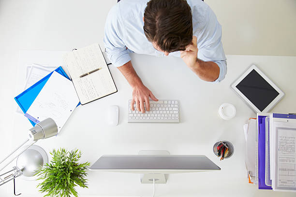istock Overhead View Of Businessman Working At Computer In Office 527614757