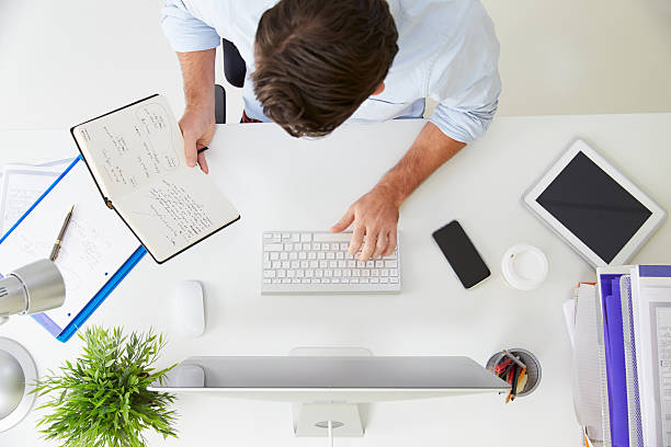 istock Overhead View Of Businessman Working At Computer In Office 527614787
