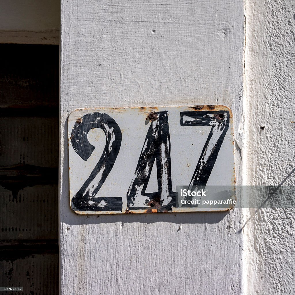 Number 247 House number two hundred and forty seven. Black lettering on a white background. Black Color Stock Photo