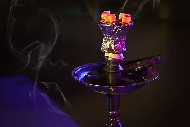 Photo of Hookah with burning coals in the night
