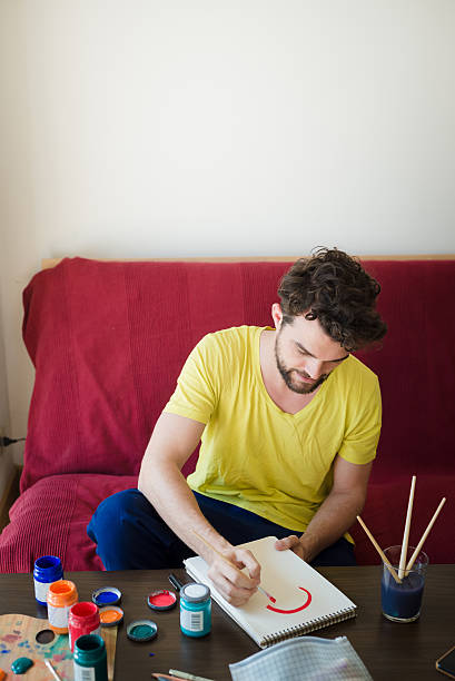 istock handsome hipster modern man painting 527617221