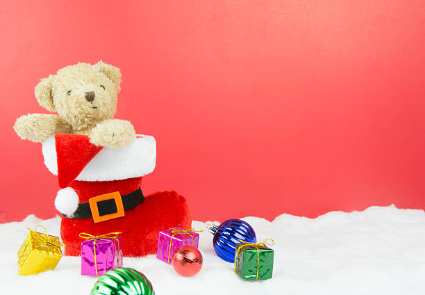 istock Santa boots and bear and christmas balls with gift 527617539