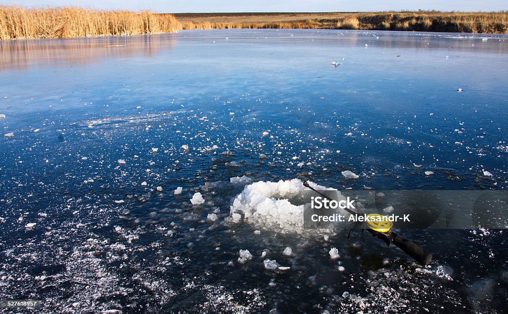 winter fishing winter fishing rod lying on the ice near the hole to fish Ice Fishing Stock Photo