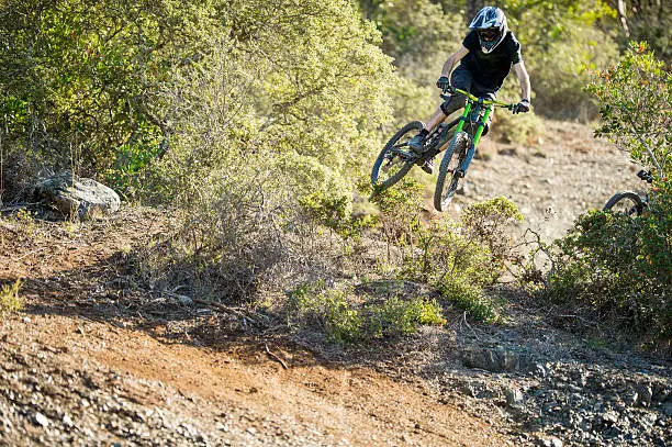 Young man doing bike jump