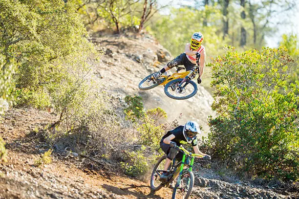 Young man doing bike jump