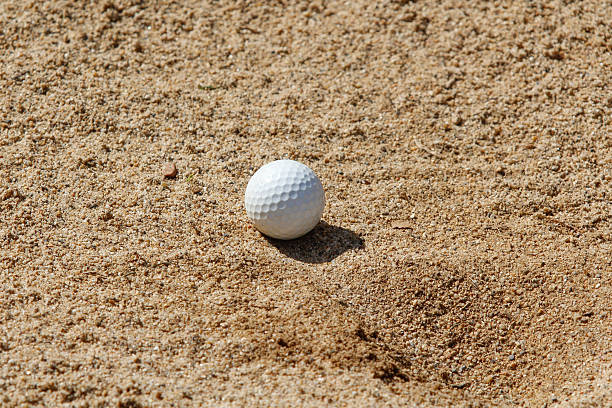 istock golf ball in a sand trap 527631673