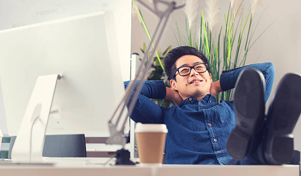 istock Asian businessman sitting at his desk relaxing 527631799