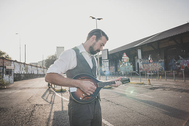 istock handsome big moustache hipster man playing mandolin 527631909