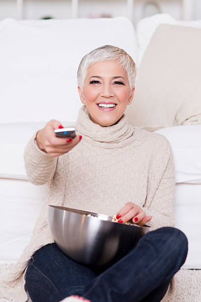 istock Mature woman watching TV 527632911
