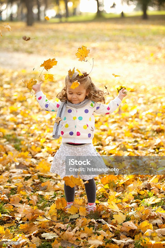 Happy Kid Throwing Leaves Outdoor In Park Active Lifestyle Stock Photo