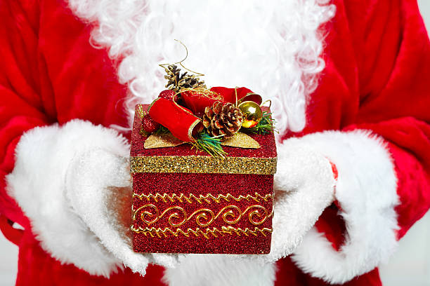istock Hands of Santa Claus with gift 527633721