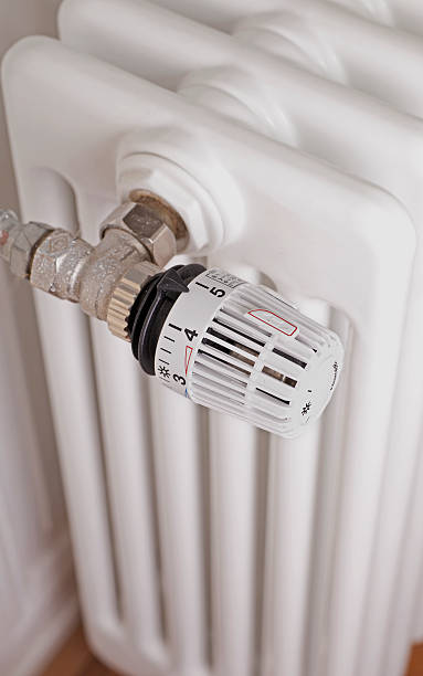 istock White radiator with white thermostat 527634205