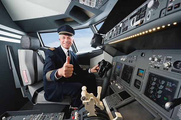 senior volo capitano con pollice in su in una cabina di pilotaggio aereo - pilot cockpit flying business foto e immagini stock