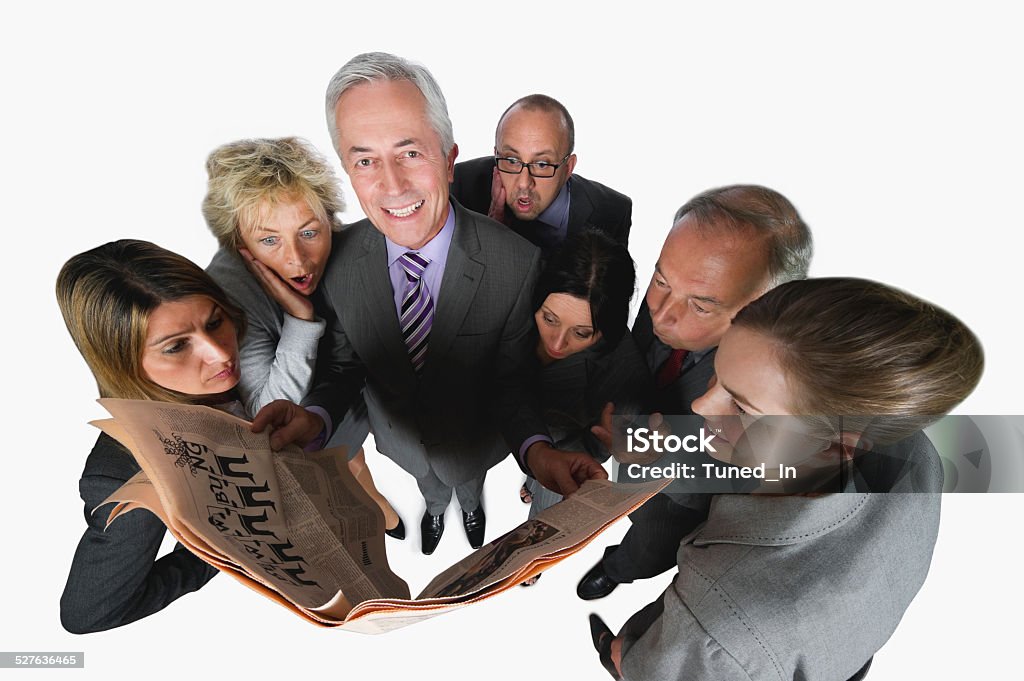 Business people reading newspaper against white background elevated view Adult Stock Photo
