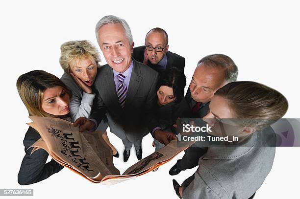 Business People Reading Newspaper Against White Background Elevated View Stock Photo - Download Image Now