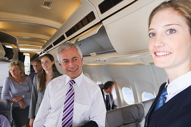 istock Businessman smiling at air hostess on airplane 527636525