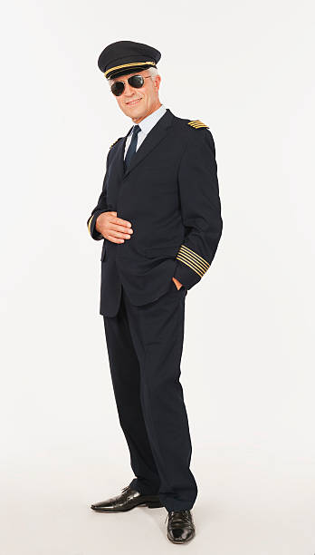 istock Close up of senior flight captain standing on white background 527636745
