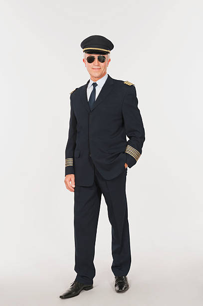 istock Close up of senior flight captain standing on white background 527636749