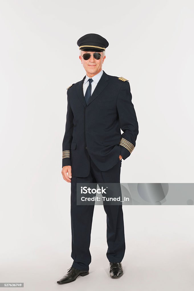 Close up of senior flight captain standing on white background Pilot Stock Photo