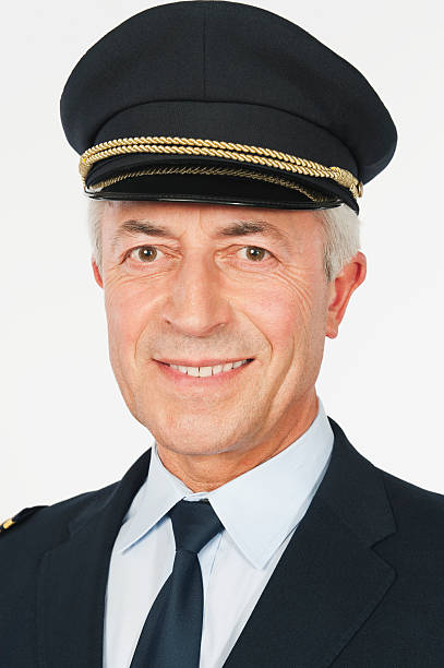 istock Close up of senior flight captain on white background 527636753