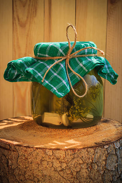 istock Jar pickled cucumbers wooden stump 527637561
