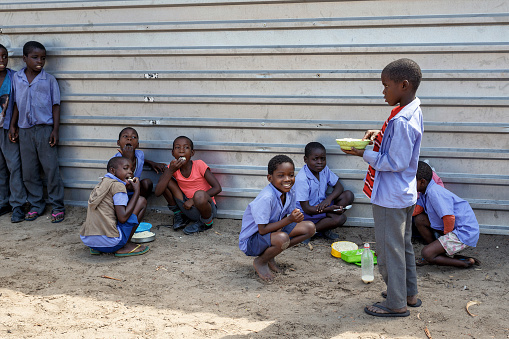 Kavango,Namibia - October 15, 2014: Happy Namibian school children waiting for a lesson. Kavango was the region with the highest poverty level in Namibia, more than 50% of the population were classified as poor. 