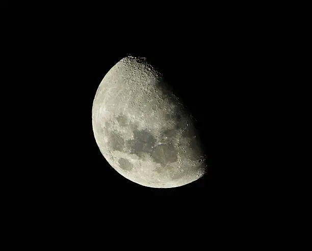 telescopic view of the first quarter moon